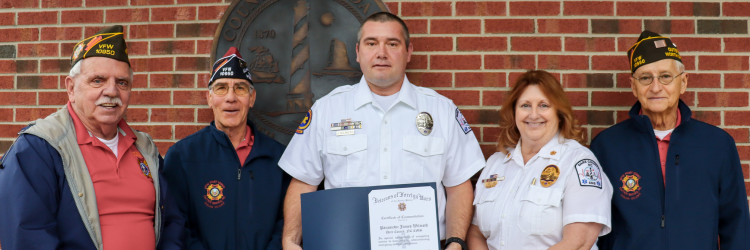 Image of Outer Banks VFW Post 10950 members standing with James Wilmoth.