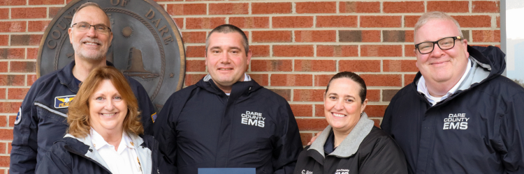 Image of Dare County EMS and Dare MedFlight employees standing with James Wilmoth.