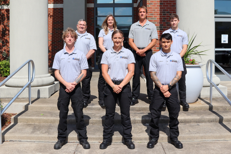 Image of the seven paramedic graduates standing together.