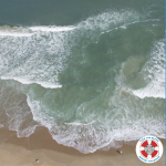 Aerial image of a rip current along a beach. The "Love the Beach, Respect the Ocean" logo sits in the bottom right corner of the photo.