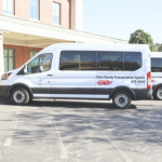 Image of Dare County Transportation vans parked in a parking lot.