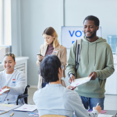 Image of voters checking in at a polling precinct.