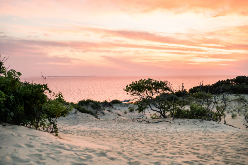 Image of a sunset along the sound behind Jockey's Ridge State Park.