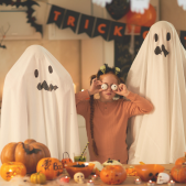 Kids and adults in costumes at a halloween party.