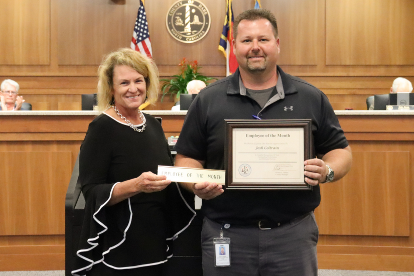 Image: Dare County's Director of Public Health Dr. Sheila Davies (left) presenting the award to Joshua Coltrain.