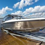Image of a boat on a trailer backing into the water.