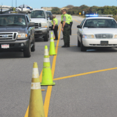 Image of Dare County police officers at a checkpoint checking for reentry passes.