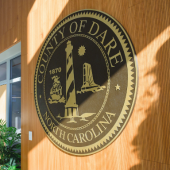 Image of the official Dare County, North Carolina county seal hanging on a wall