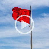 Image of a red flag with a play button overlay.