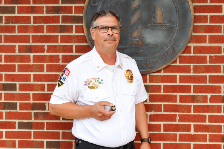 Captain Jeffrey Mitchell, Dare County EMS, holding his 25-year pin