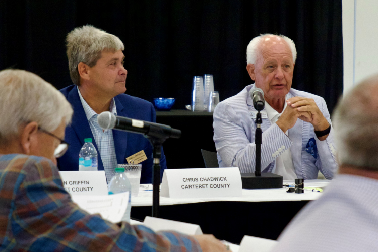 Carteret County Chairman Chris Chadwick sits next to Dare County Chairman Bob Woodard during the meeting.