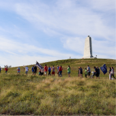 Image of a large group hiking up the Wright Brother's Monument on 9.11.24.
