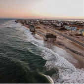 Image of homes precariously standing in the ocean in Rodanthe.