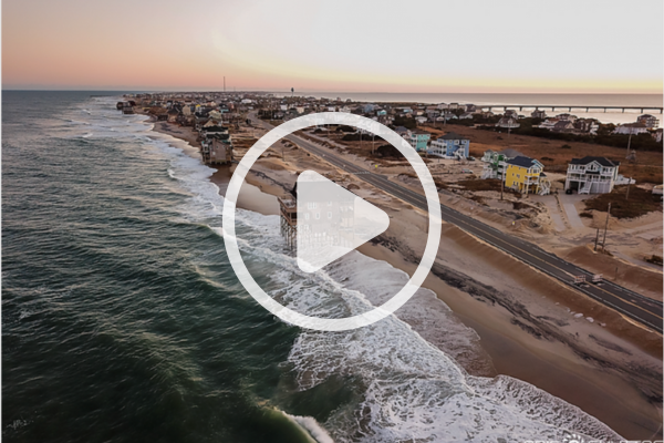 Aerial image of Rodanthe. Play button overlay signifies a video will play when clicked. 