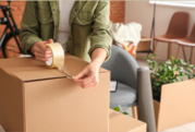 Person using packing tape to seal box