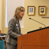 Image of Donna Creef presenting to the Board of Commissioners at the podium.