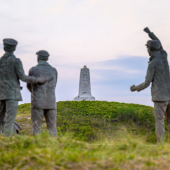 Image of the replica statues at the Wright Brothers National Monument.