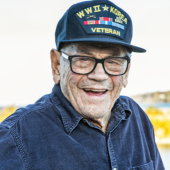 Image of an older man wearing a veteran of WWII and Korea hat with an Air Force pin.