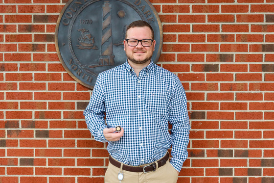 Image of Michael Elliot standing with his pin.