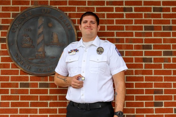 Image of Brenden Lindsay holding his pin.