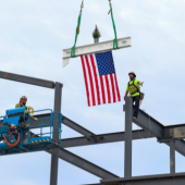 Image of the final beam for the Dare Early College being lifted into place.