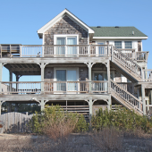 Image of a cedar shake two story house.