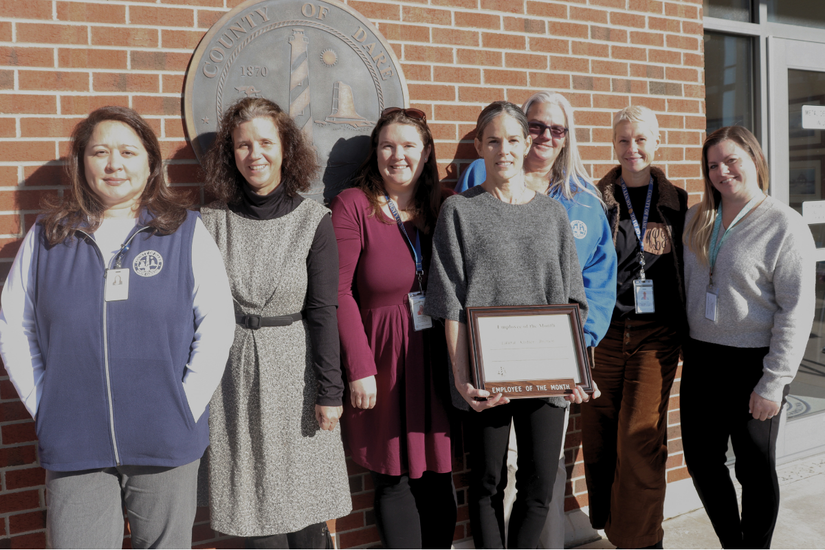 Image of Laura Kistler-Brown with her Dare County Department of Social Services colleagues who attended the presentation.