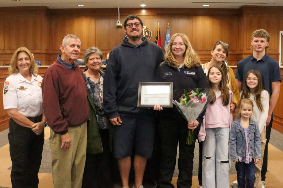 Kirsten “Schae” Britt stands a the podium with her family and Chief Collins after the employee of the month presentation.