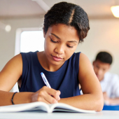 Image of a young girl writing in a journal.