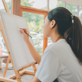 Image of a young woman beginning a drawing.