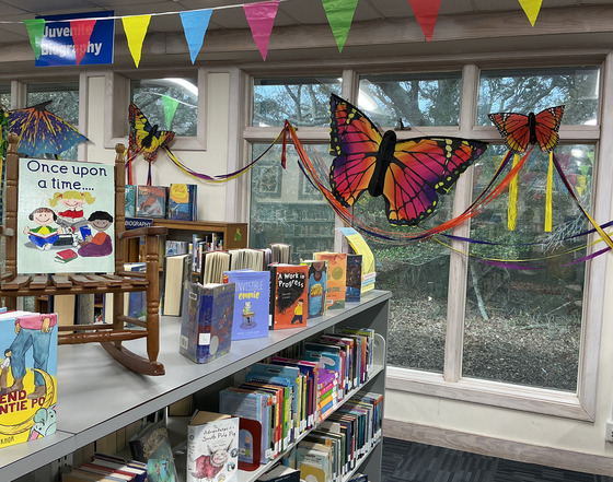 Butterfly decorations, storytime rocker, and books on display at Kill Devil Hills Library