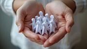 hands holding paperdoll people 