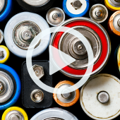 Image of old batteries. A play button overlay signifies that a video will play when clicked. 