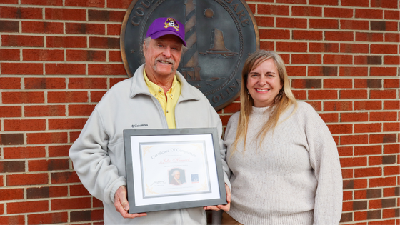 Murray Parker holds his certificate next to Dare County GIS Analyst and Dare A250 History Committee Member Kristen Stilson.