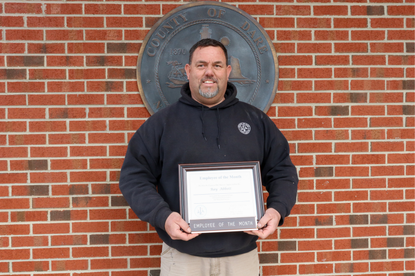 Plant Maintenance Mechanic Ray Abbott holds his Employee of the Month certificate.