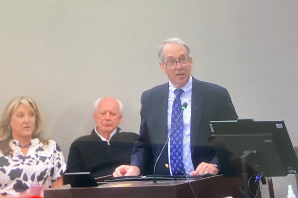 Dare County Manager Bobby Outten speaks at a podium.