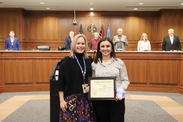 Dare County Human Resources Director Elizabeth Reilly presents the award to Clerk to the Board of Commissioners Skyler Foley