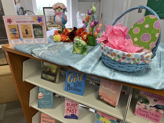 April display at Hatteras Library with flowers, bunny, frog, eggs and springtime books