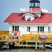 Image of the Roanoke Marshes Lighthouse in Manteo, decked out in patriotic decorations.