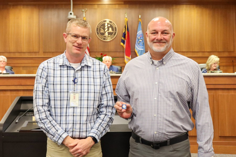 Image of Matt Hester presenting the service pin to Clay Grant.