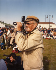 Image of Aycock Brown holding up his camera to take a photo.