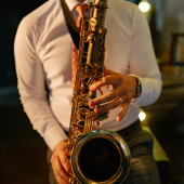 Close-up image of a man playing a saxophone. 
