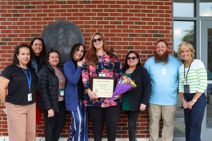 Dare County Department of Health & Human Services Accounting Assistant Stormy Heroux stands with her colleagues.