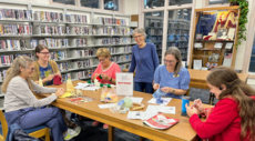 Adults participating in Knit Knights fiber arts group at Kill Devil Hills Library