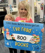 Child holding sign that says I've read 800 books before kindergarten
