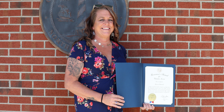 Image of Becca Harich holding her award