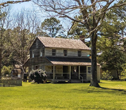 Image of the exterior of the Island Farm historical wooden building.