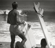 Black and white photos of two surfers watching surfing  on the beach in the Outer Banks