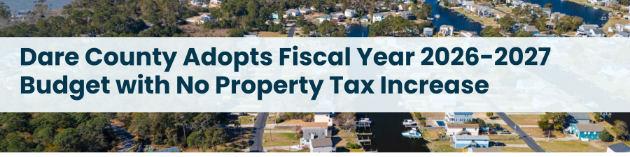 Heading: Dare County Adopts Fiscal Year 2026-2027 Budget with No Property Tax Increase. Aerial image of houses in Colington Harbour.