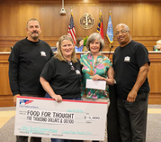 Garage Band Charities founders present a $5,000 check to Food for Thought.